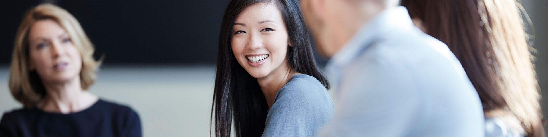 Group of people in meeting smiling