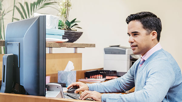 Man learning at desk on computer